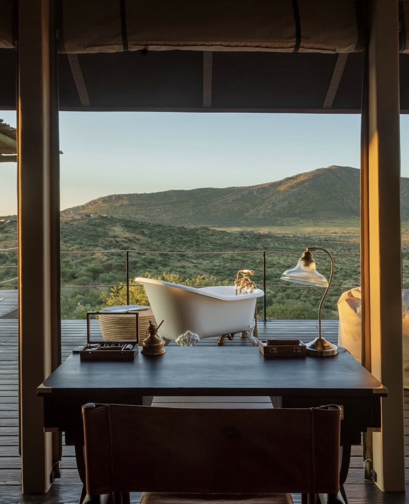 Tented suite writing desk and roll-top bath open to the bush