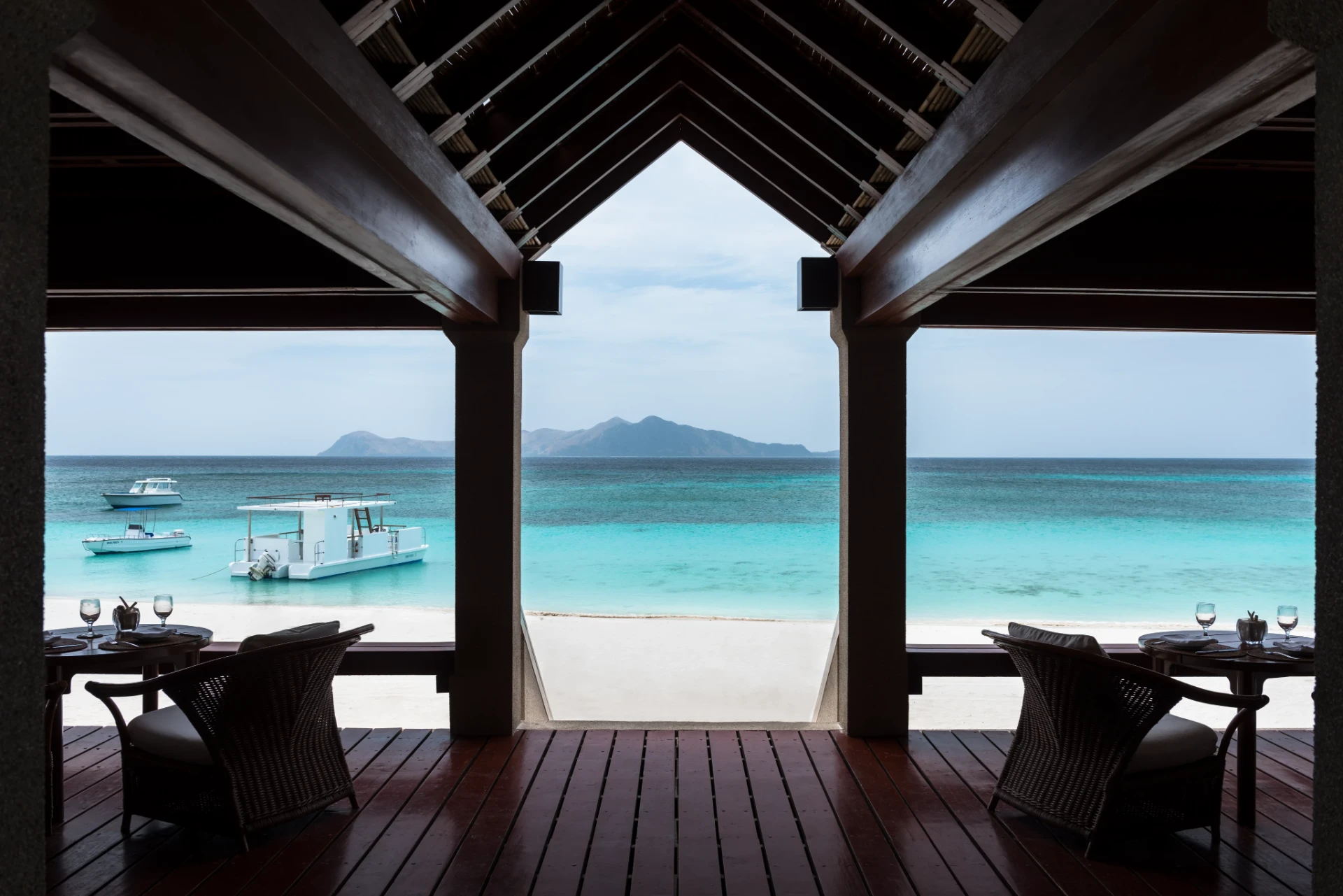Open-air pavilion framing clear water and islands in the Philippines