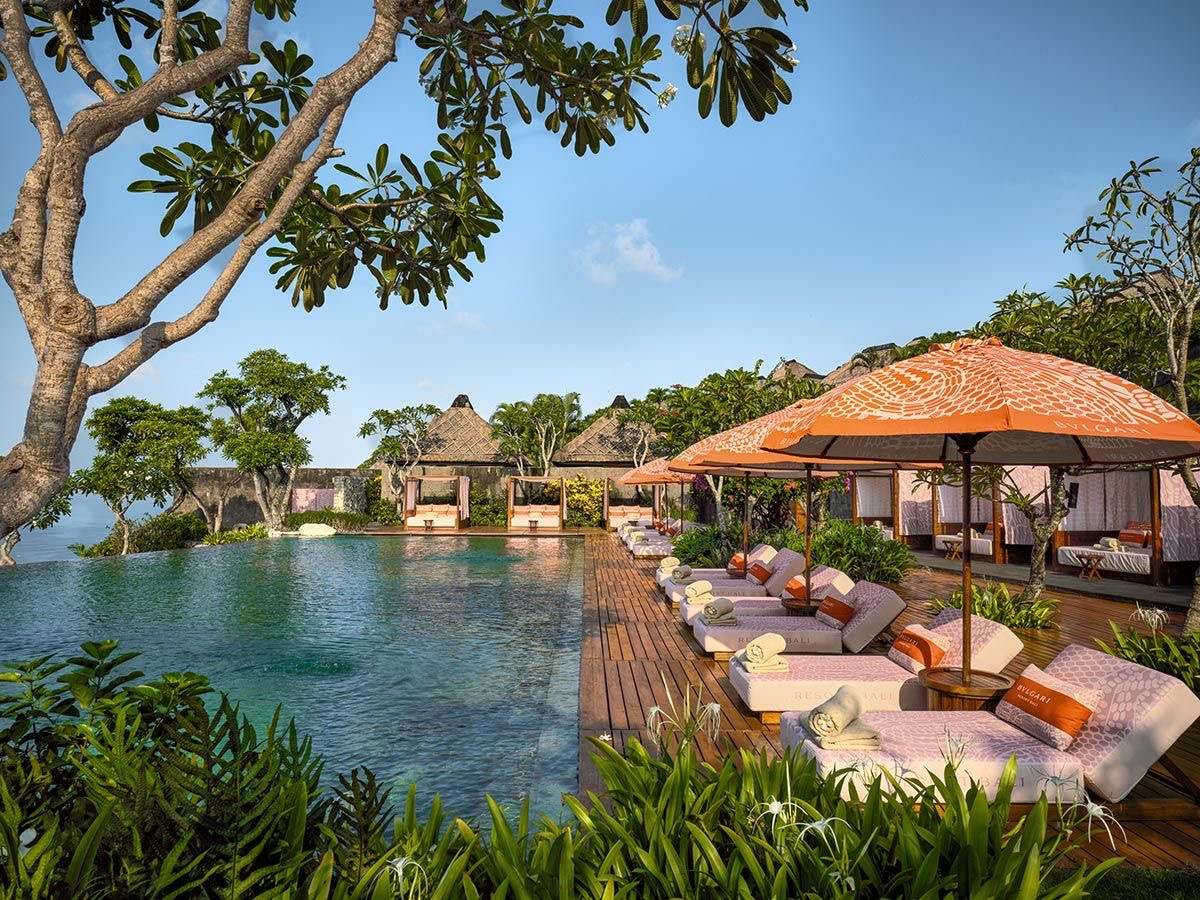 Clifftop pool and shaded cabanas surrounded by tropical gardens