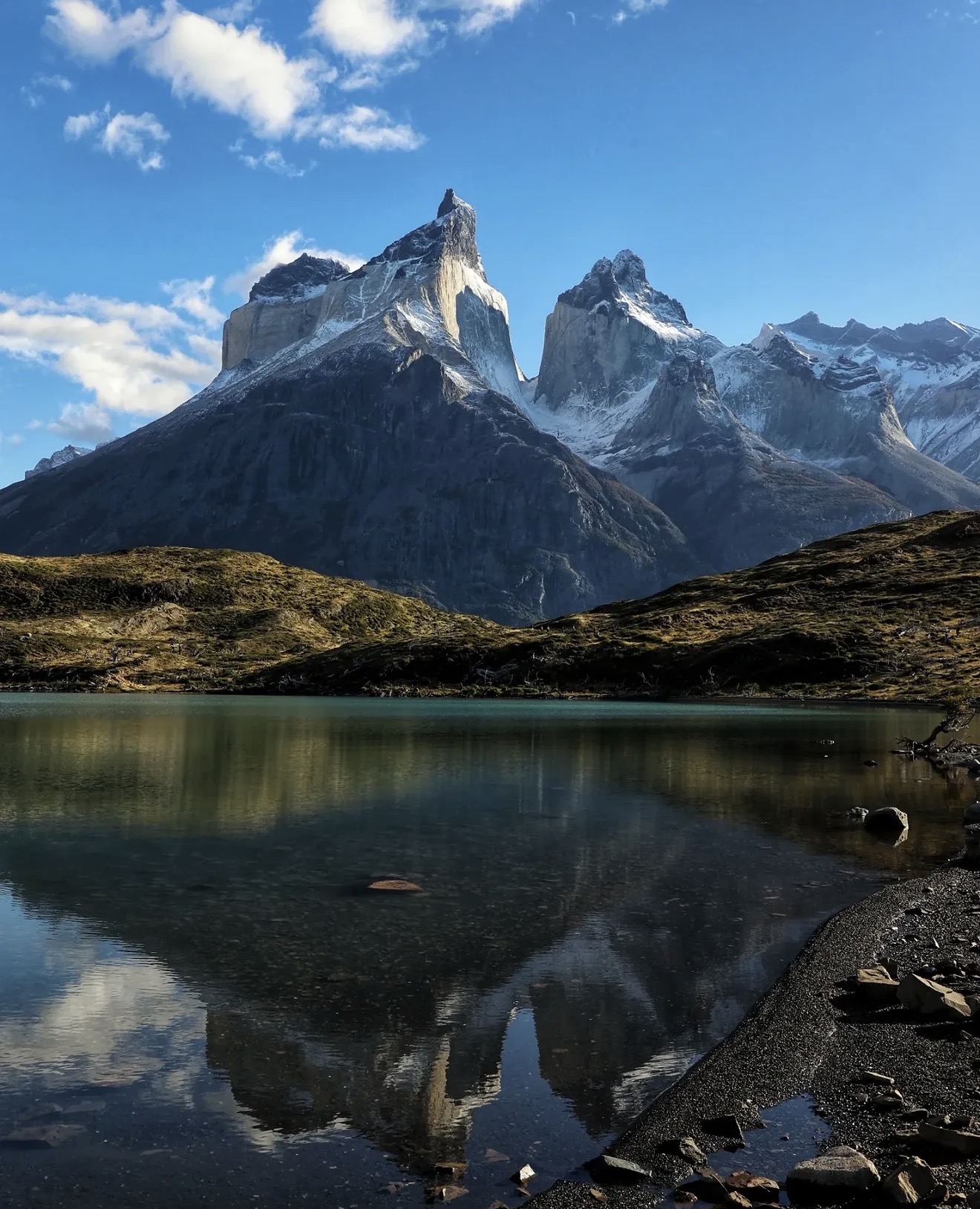Granite towers reflected in a still Patagonian lake