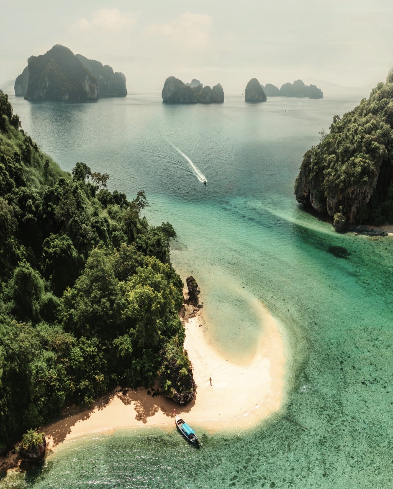 Aerial view of a secluded turquoise cove among limestone islands
