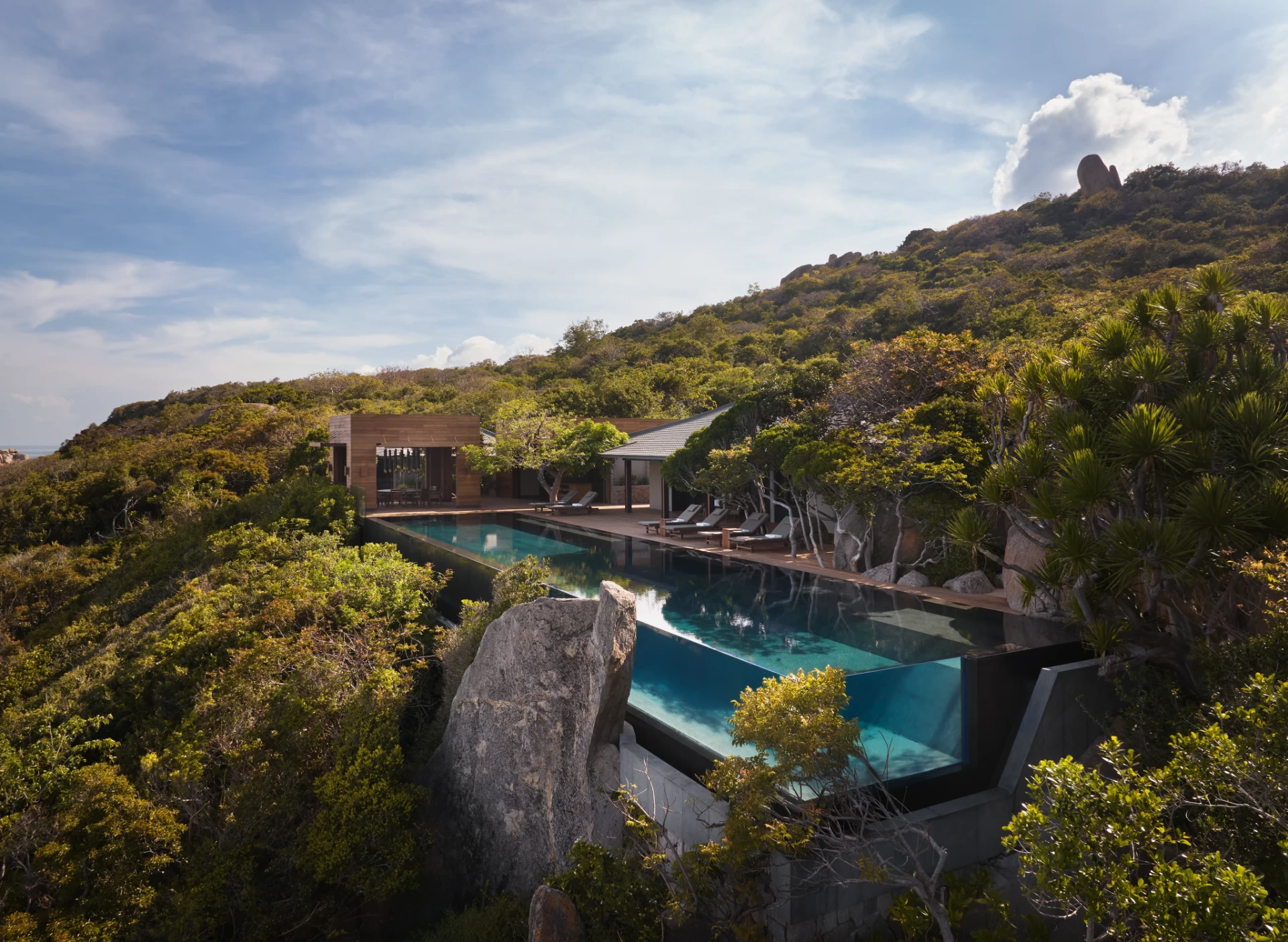 Clifftop infinity pool surrounded by wild coastal landscape in Vietnam