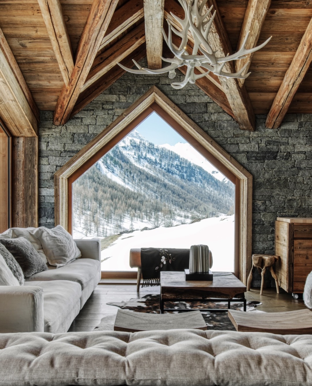 Stone and timber chalet framed around a snowy mountain view