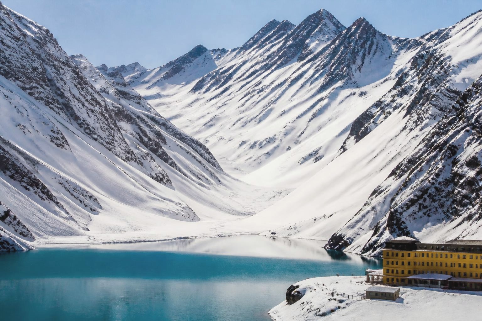 Snow bowl above the turquoise lake at Portillo in the Chilean Andes
